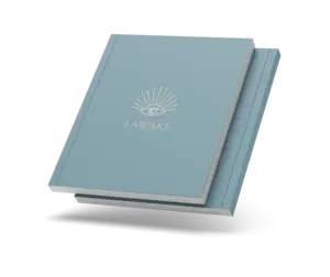 Closed I AWAKE journal with the eye cover and a thin coloured spine, on a transparent background.